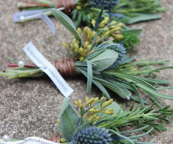Boutonnieres were fashioned from herbs, thistle and seeded eucalyptus.